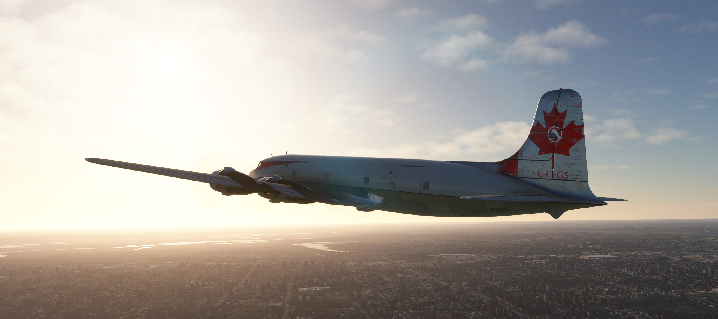 Classic aircraft flying over a city during sunset
