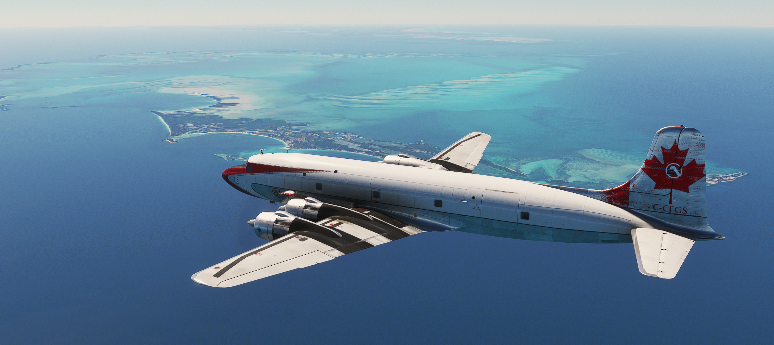 Classic aircraft cruising over bright blue coastal water